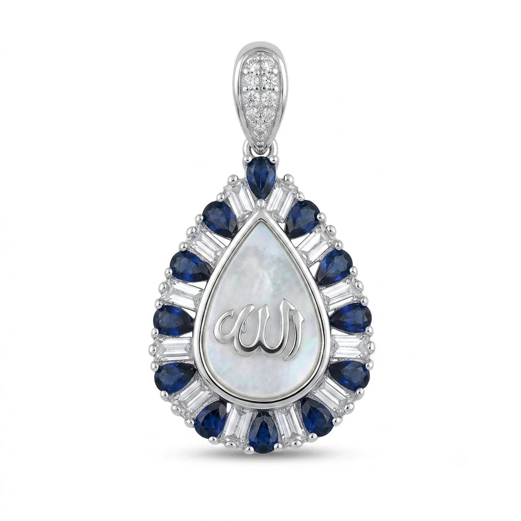 A teardrop-shaped pendant featuring a central white iridescent stone with a silver script engraving, surrounded by a halo of round and baguette-cut deep blue sapphires and clear stones, set in a polished silver-tone metal on a white background.