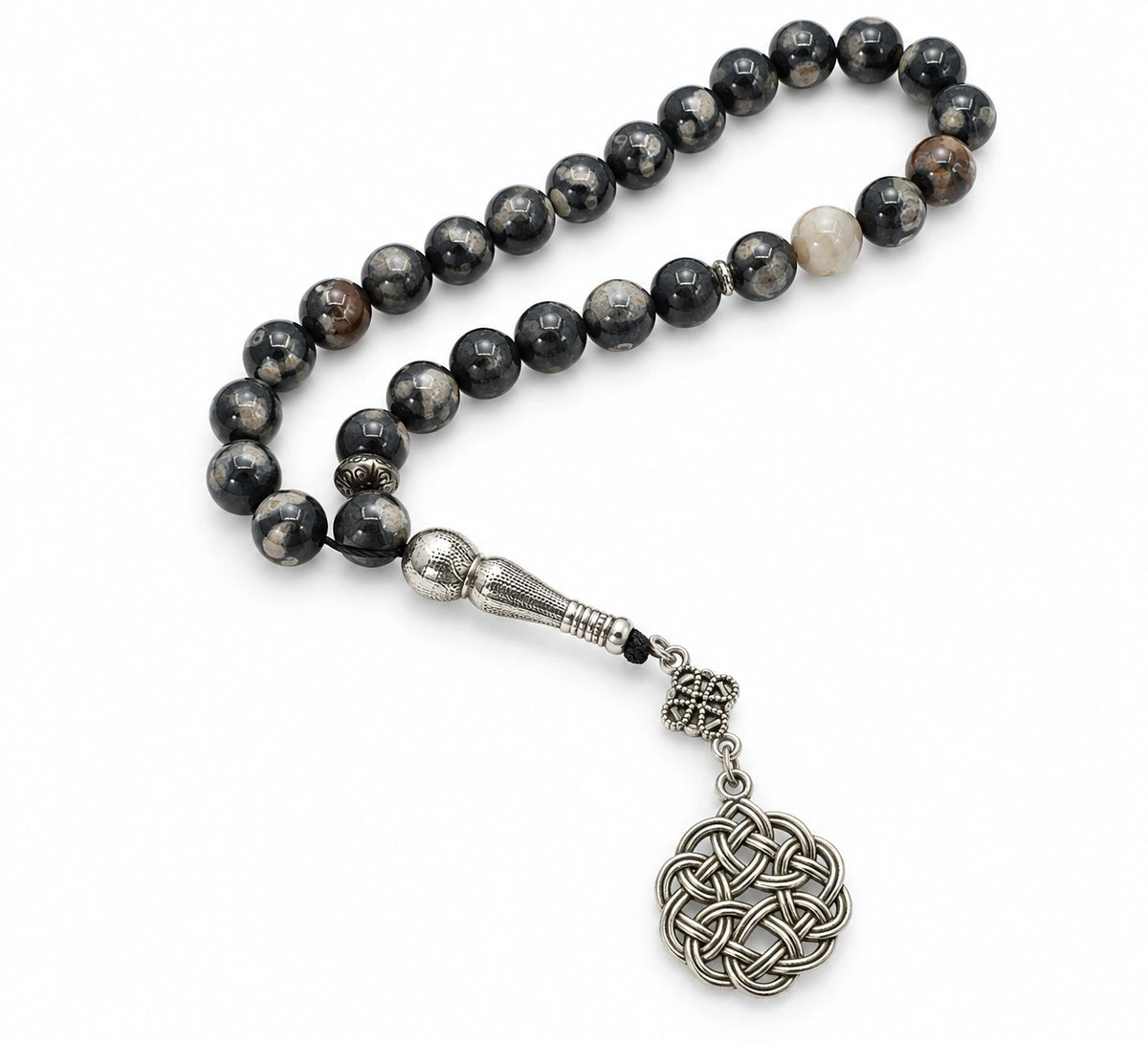 Black Agate tasbih with grey and cream markings, silver-tone imame and circular knot ornament on white.