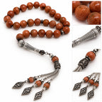 Goldstone tasbih detail collage showing sparkling copper-brown beads, textured imame and openwork tassel ornaments.
