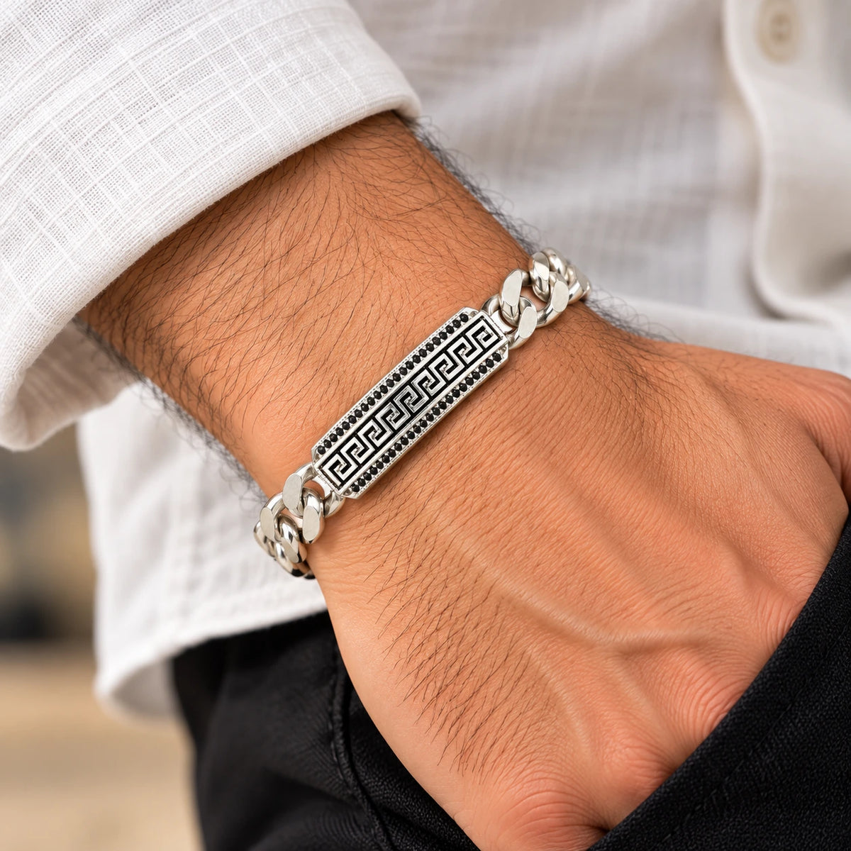 Men's 925 sterling silver Greek key ID bar bracelet worn on man's wrist with white shirt, lifestyle shot, Fine Silver KSA