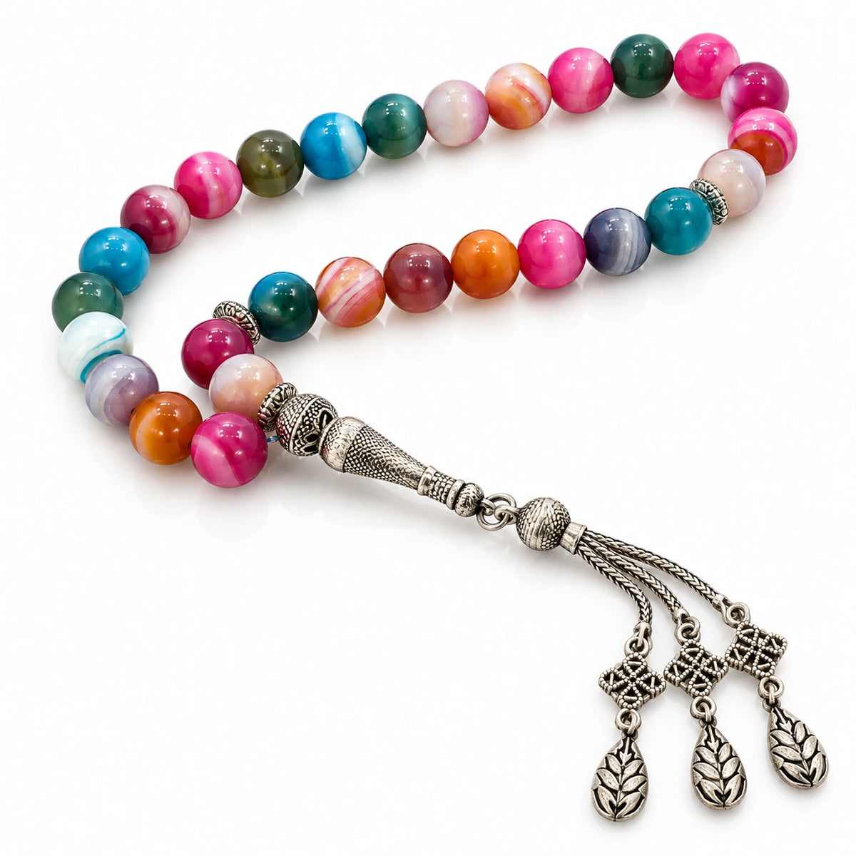 Multicolor Agate tasbih with pink, teal, green and orange beads and three silver-tone leaf-patterned charms on white.
