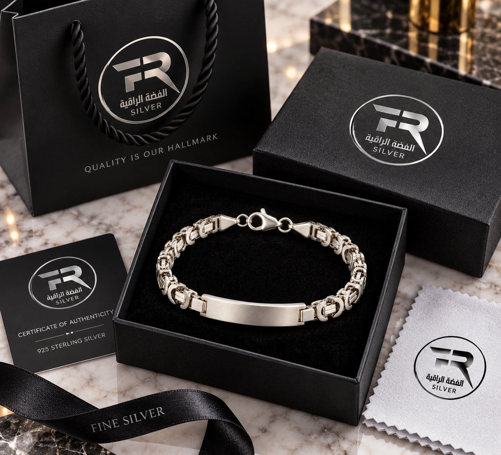 Men's 925 silver ID bar Byzantine bracelet in Fine Silver branded black gift box with certificate, polishing cloth and bag on marble surface