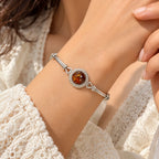 Women's 925 sterling silver amber bracelet worn on woman's wrist, close-up lifestyle shot with white lace sleeve, Fine Silver KSA