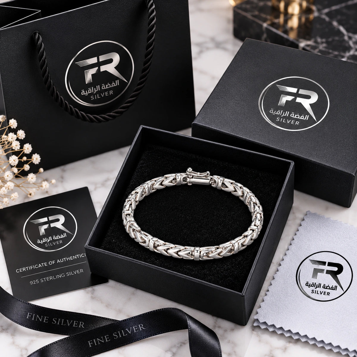 Men's 925 silver chevron Byzantine bracelet in Fine Silver branded black gift box with certificate, polishing cloth and branded bag on marble surface