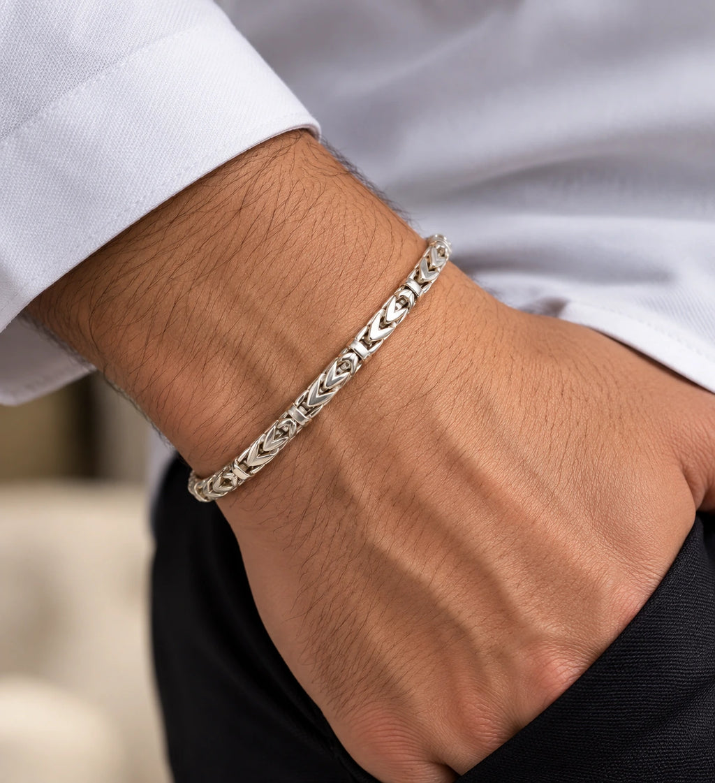 Men's 925 Italian sterling silver chevron Byzantine bracelet worn on man's wrist with white dress shirt, lifestyle shot, Fine Silver KSA