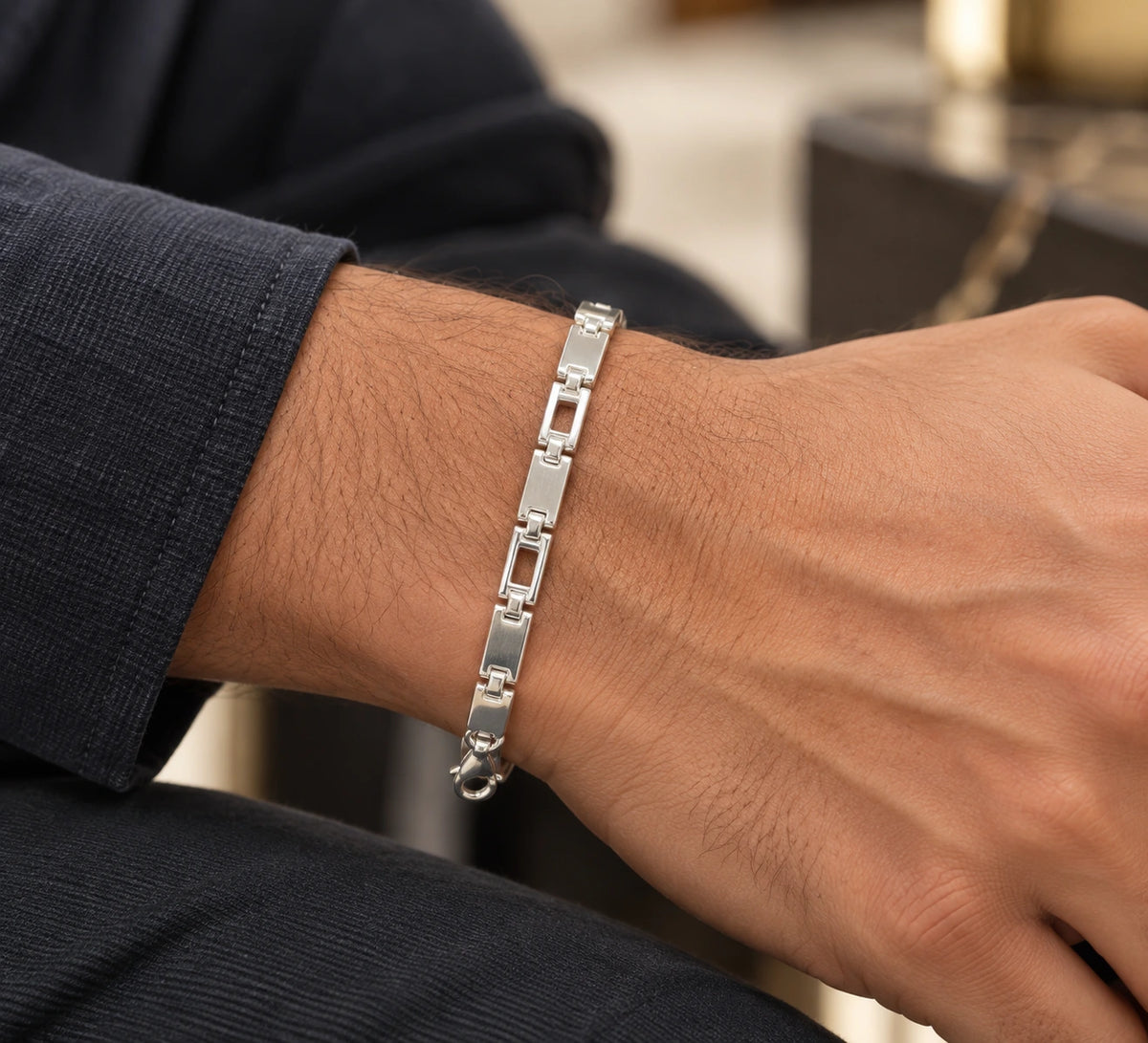 Men's 925 Italian sterling silver geometric open-link bracelet worn on man's wrist with navy suit jacket, lifestyle shot, Fine Silver KSA