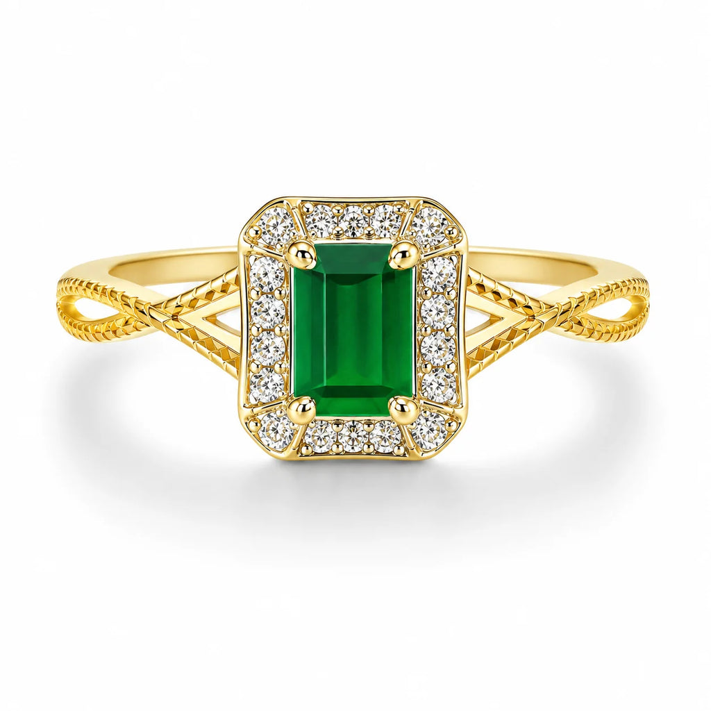 Gold ring with a green gemstone and diamond accents on a white background