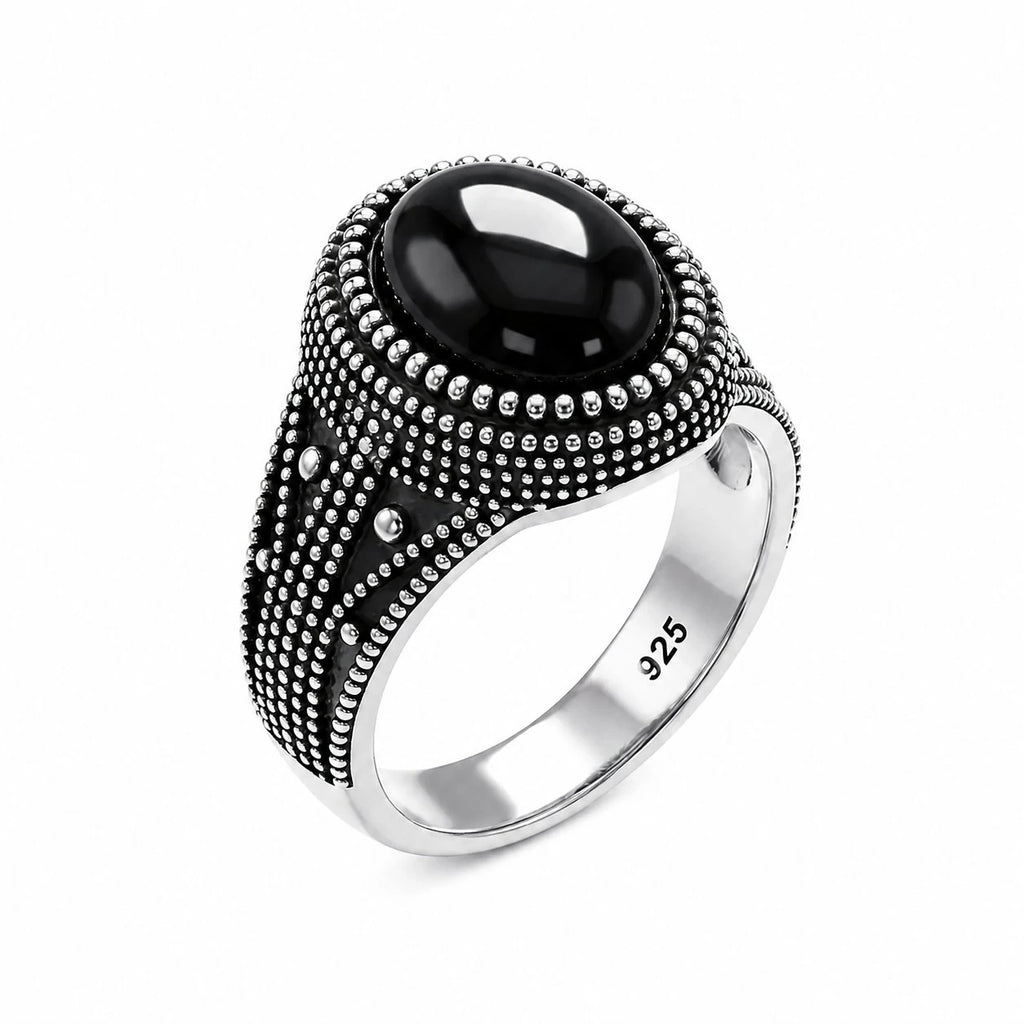 Silver ring with a black gemstone on a white background