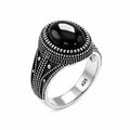Silver ring with a black gemstone on a white background