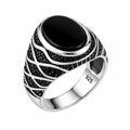 Silver ring with black gemstone on a white background