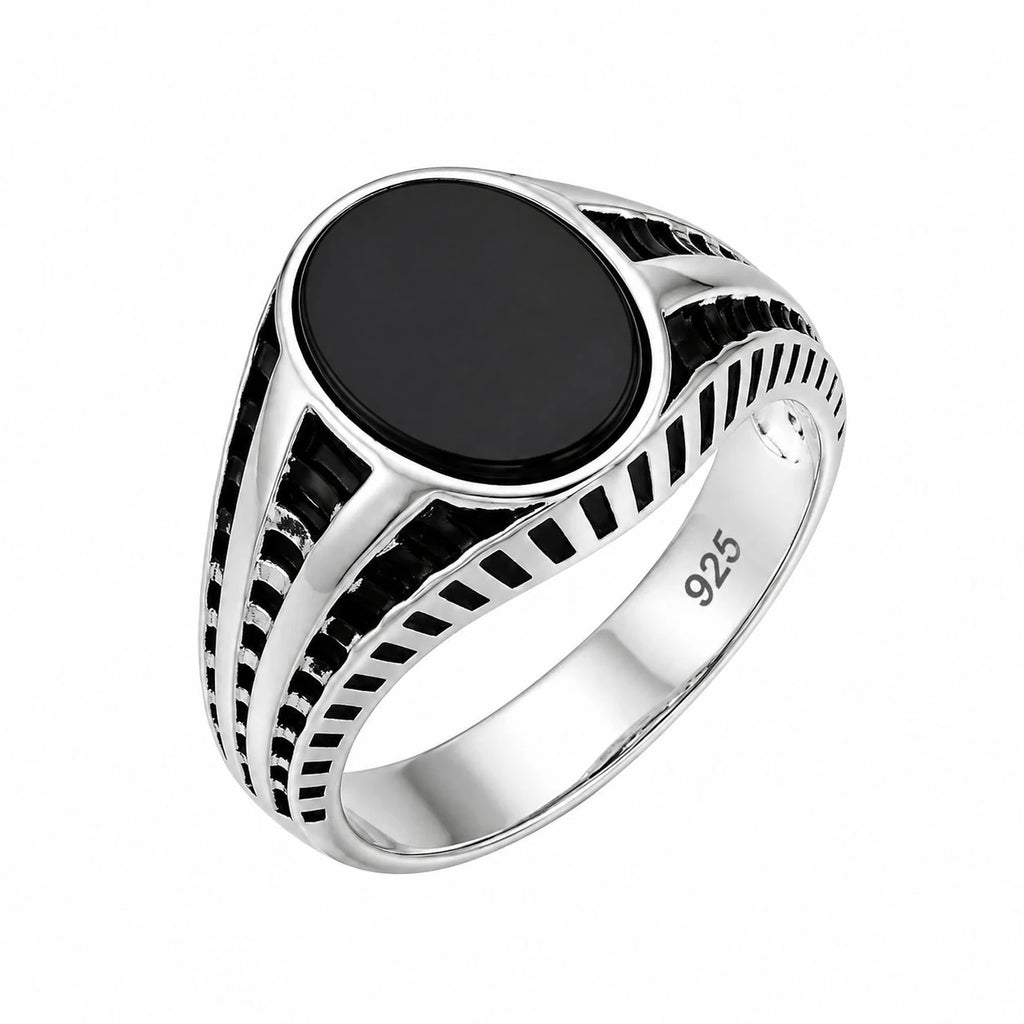 Silver ring with a black stone on a white background