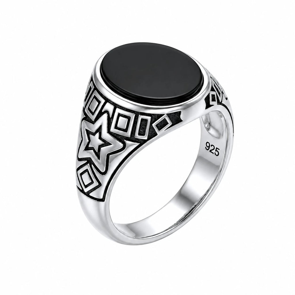 Silver ring with black stone and star design on a white background