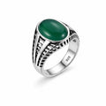 Silver ring with a green stone on a white background