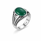 Silver ring with a green stone on a white background