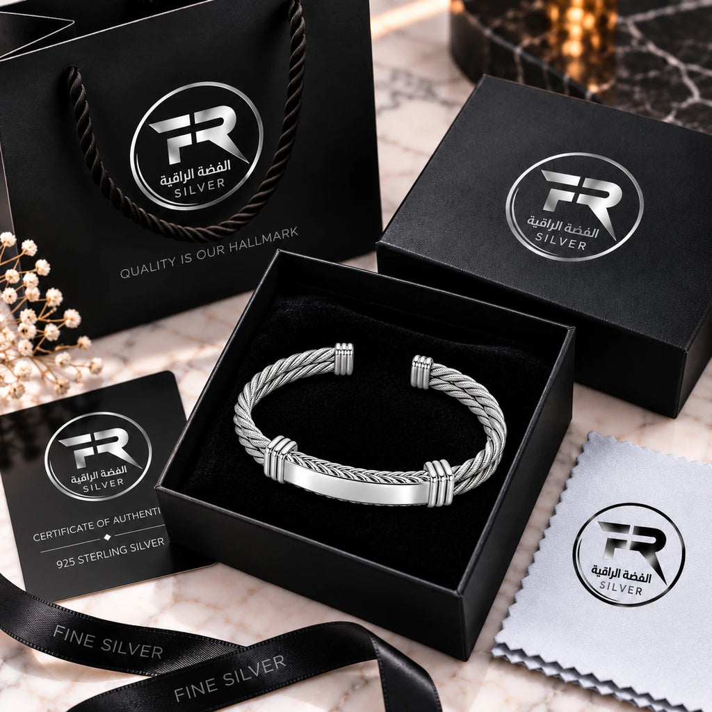 Silver cable cuff bracelet in a black presentation box with branded bag, authenticity card, ribbon and cloth.