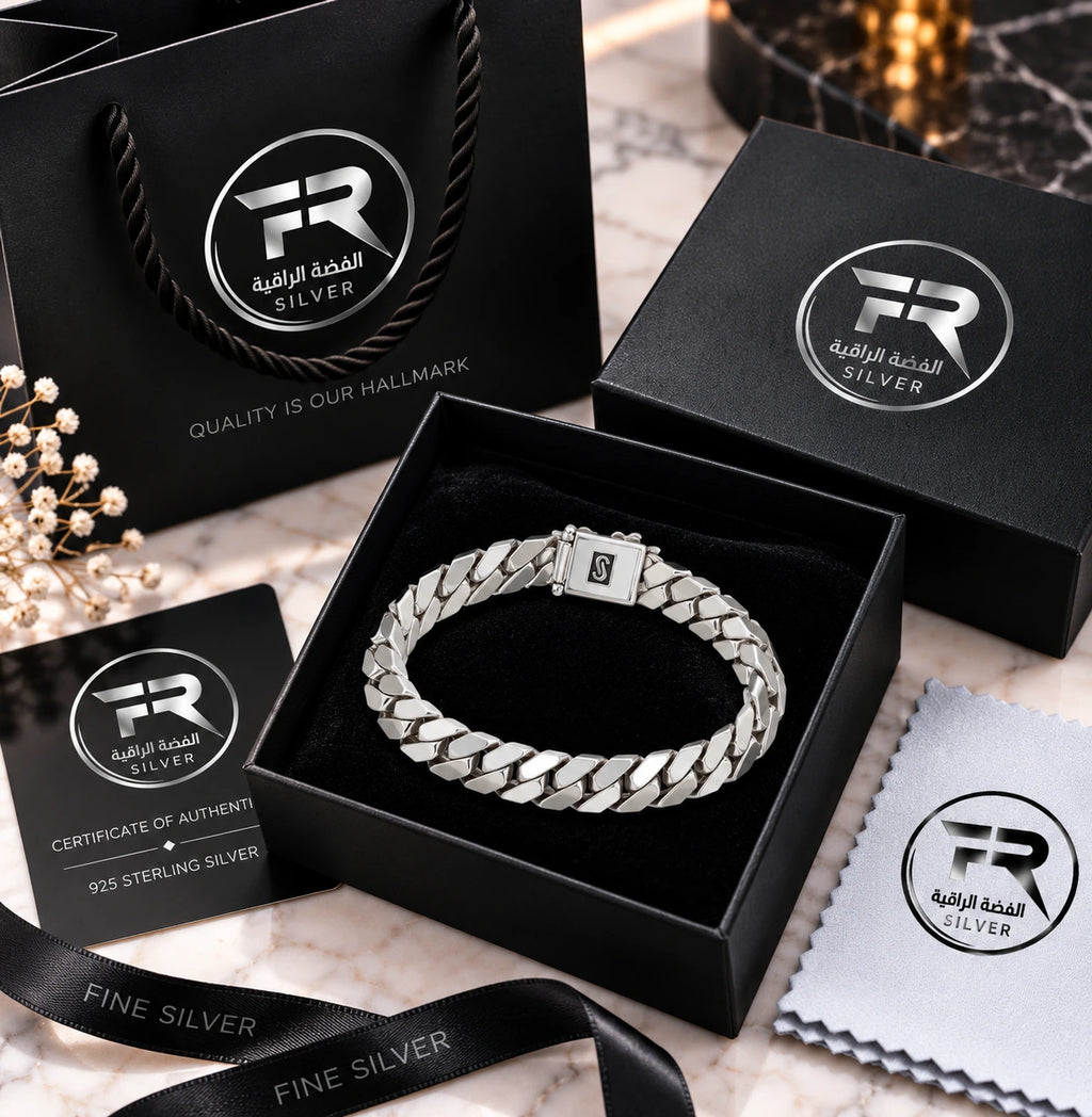Silver Cuban-link bracelet in a black presentation box with branded bag, authenticity card, ribbon and cloth.