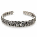 Men's silver open cuff bracelet with repeating diagonal scroll-patterned panels and dark antique-style recesses on white.
