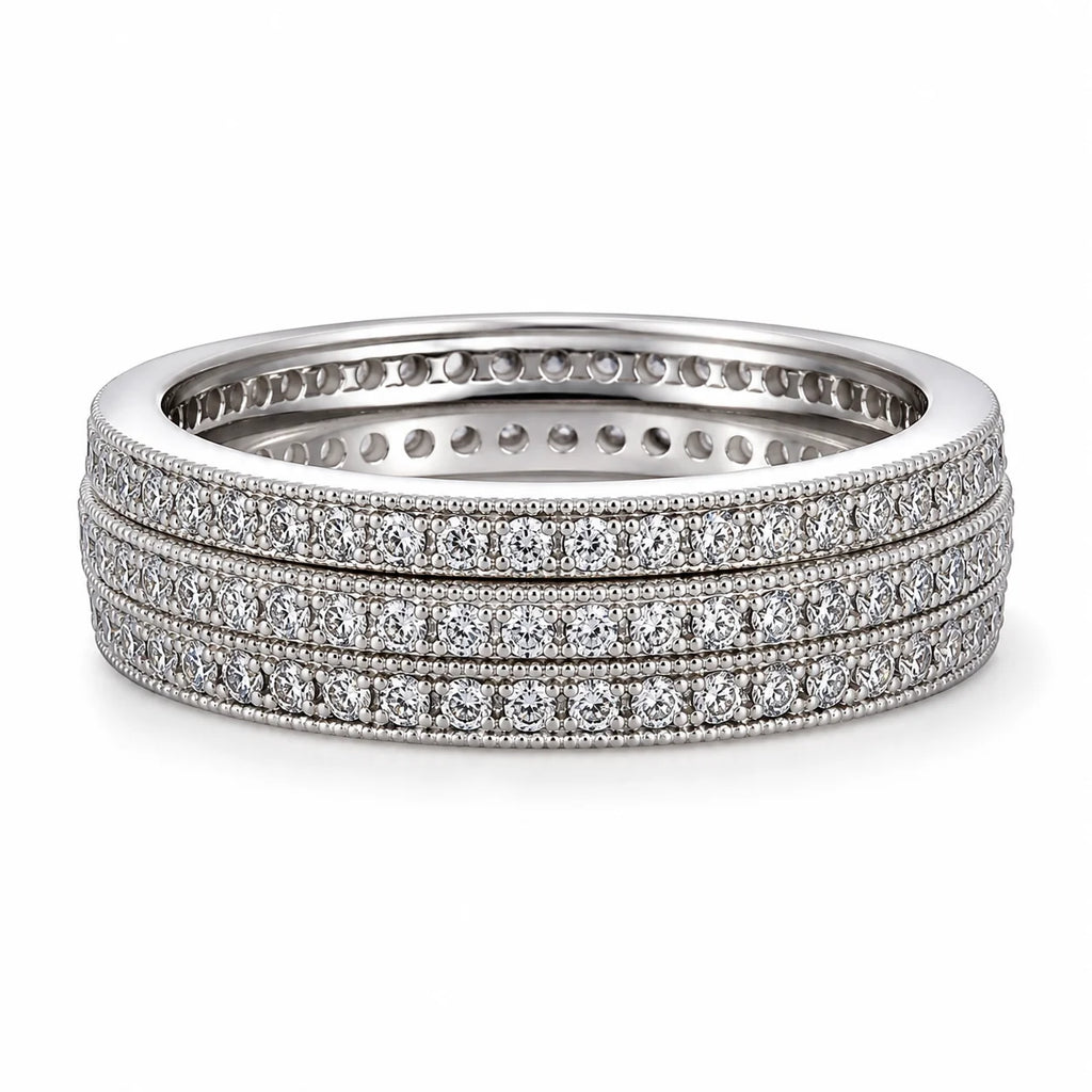 Set of three diamond-studded rings on a white background