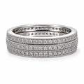 Set of three diamond-studded rings on a white background