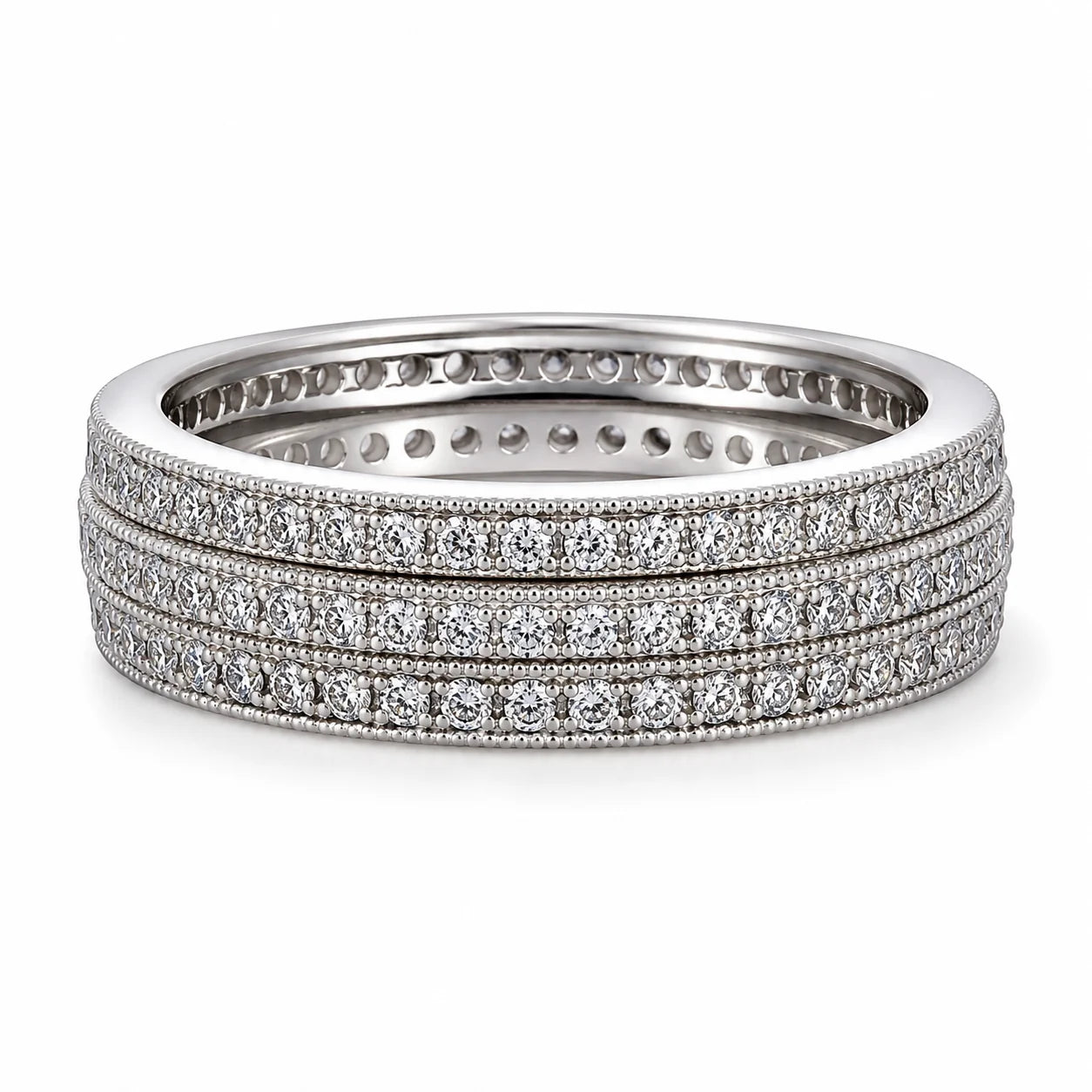 Set of three diamond-studded rings on a white background