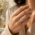Close-up of a hand wearing a diamond ring with a blurred background