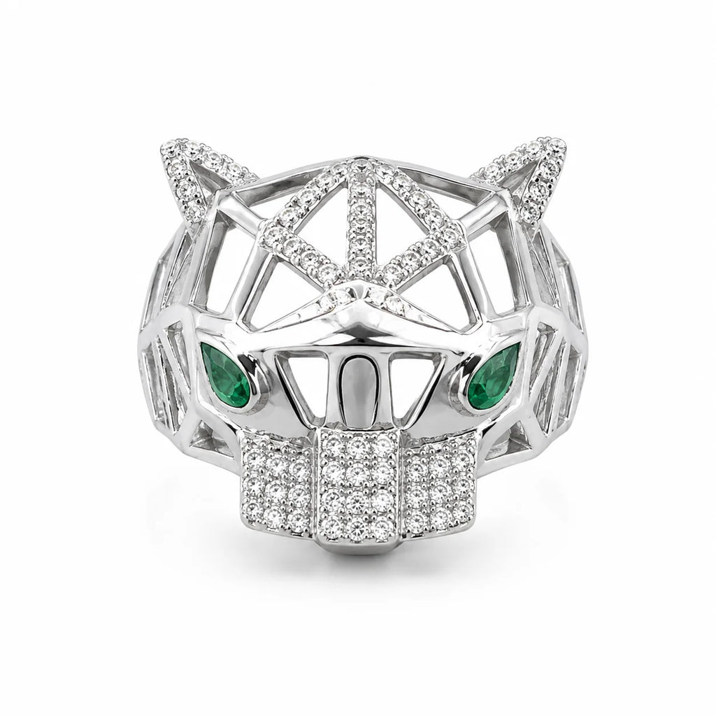 Silver panther head ring with emerald eyes on a white background