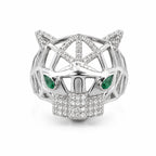 Silver panther head ring with emerald eyes on a white background