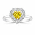 Heart-shaped ring with a yellow gemstone and diamond accents on a white background