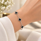 Women's 925 silver black onyx clover bracelet worn on wrist with white sleeve, lifestyle shot, Fine Silver KSA