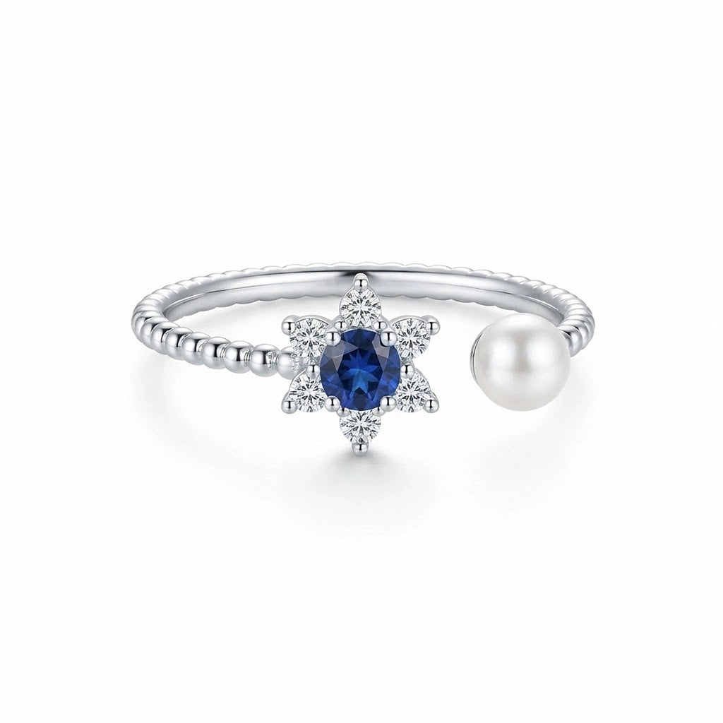 Women's 925 Italian sterling silver open adjustable ring with blue sapphire CZ star halo and freshwater pearl terminal, white background, Fine Silver KSA