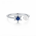 Women's 925 Italian sterling silver open adjustable ring with blue sapphire CZ star halo and freshwater pearl terminal, white background, Fine Silver KSA