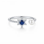 Women's 925 Italian sterling silver open adjustable ring with blue sapphire CZ star halo and freshwater pearl terminal, white background, Fine Silver KSA